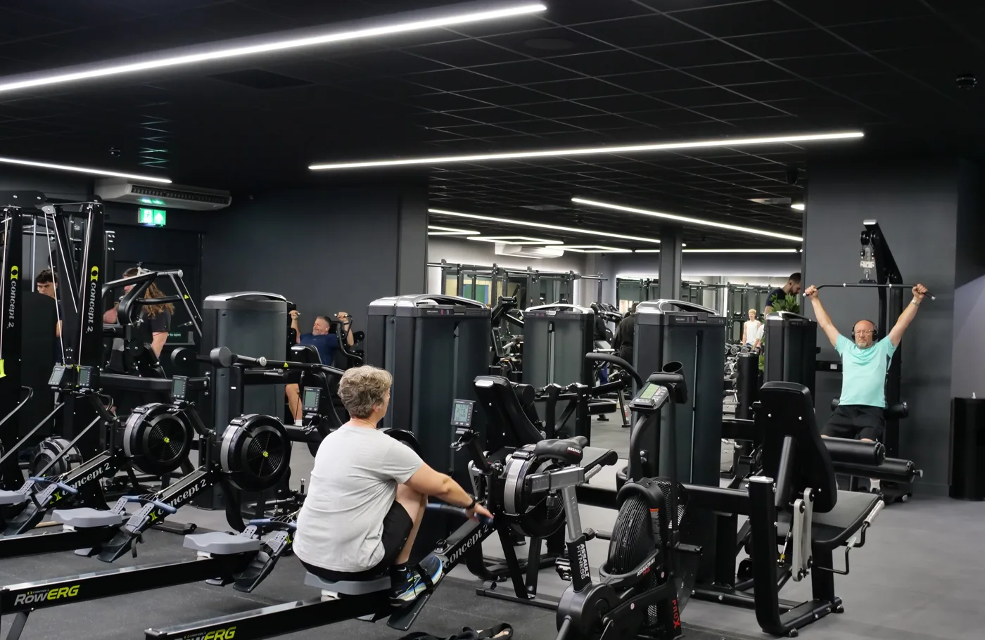 A woman on a rowing machine and a man using a cable machine among the new strength equipment at Worthing Leisure Centre