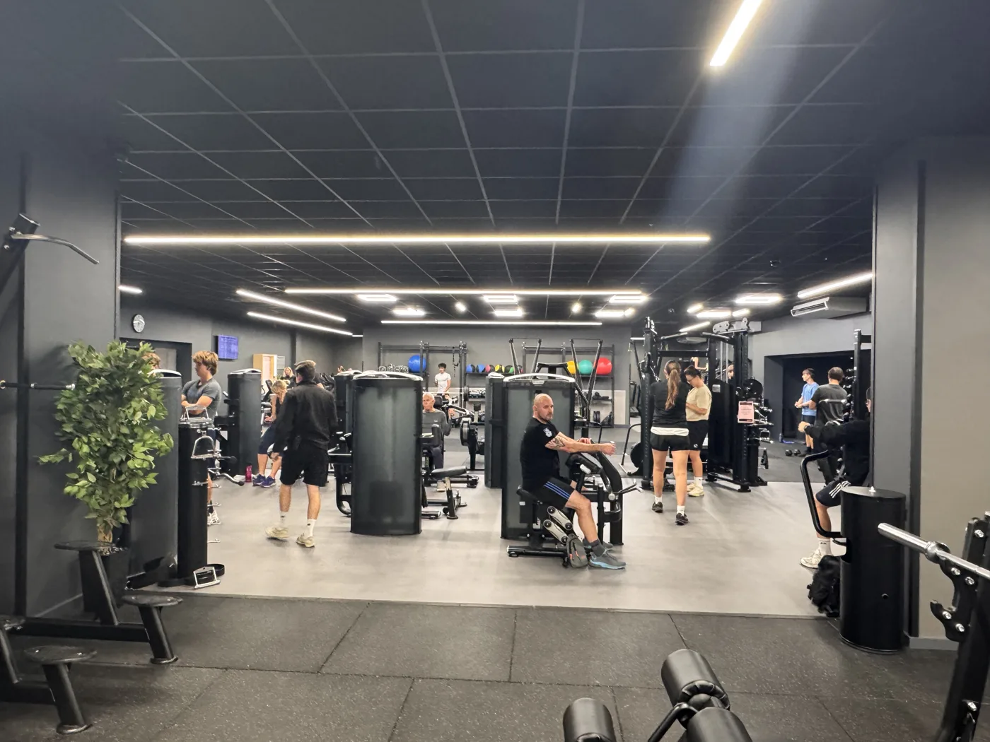 A wide view of the new strength area at Worthing Leisure Centre, with people training among the machines
